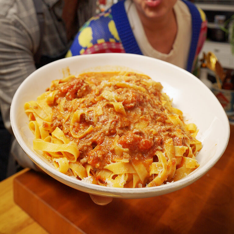a bowl of fettuccini bolognese with plant based meat