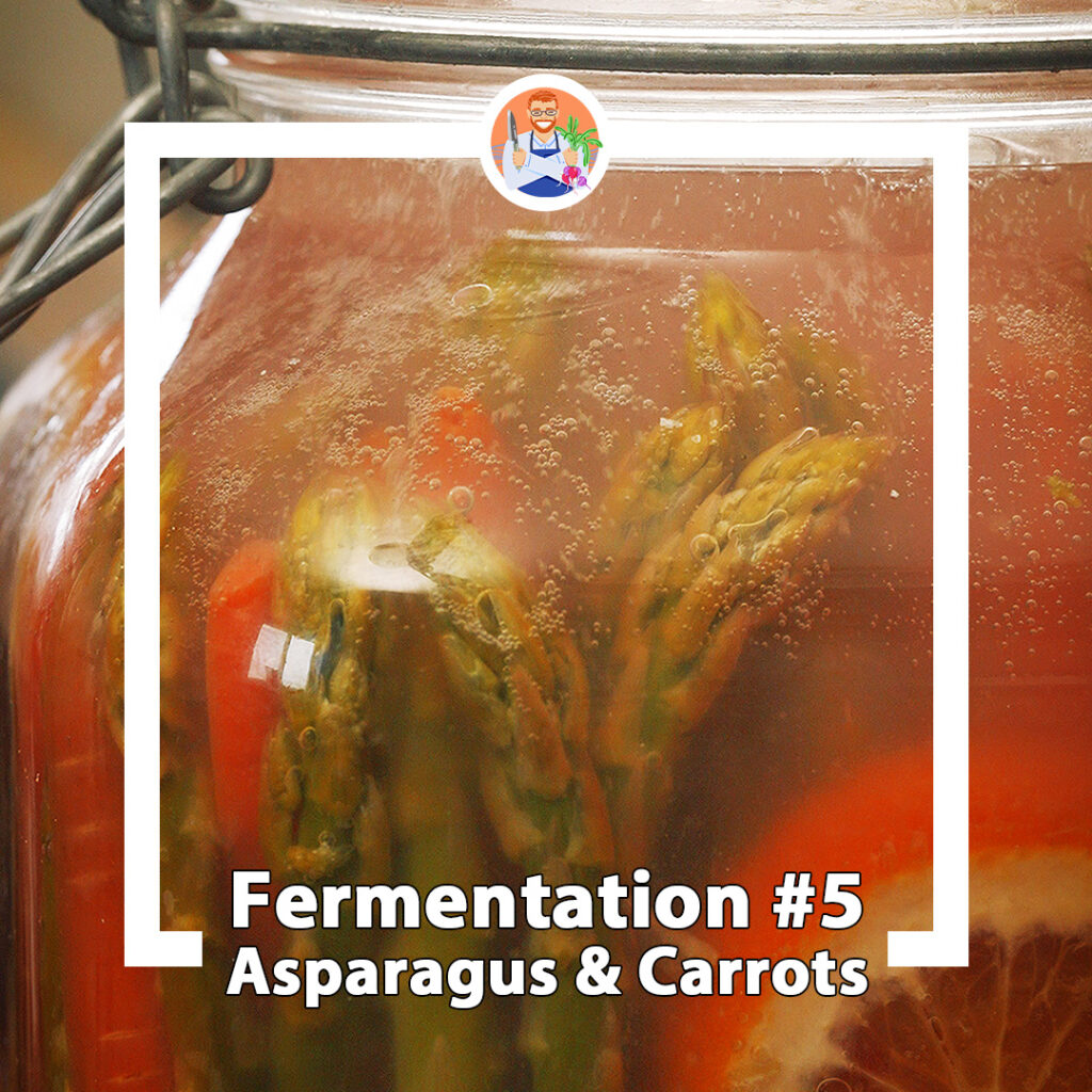 a bubbling jar full of fermented asparagus, carrots and citrus