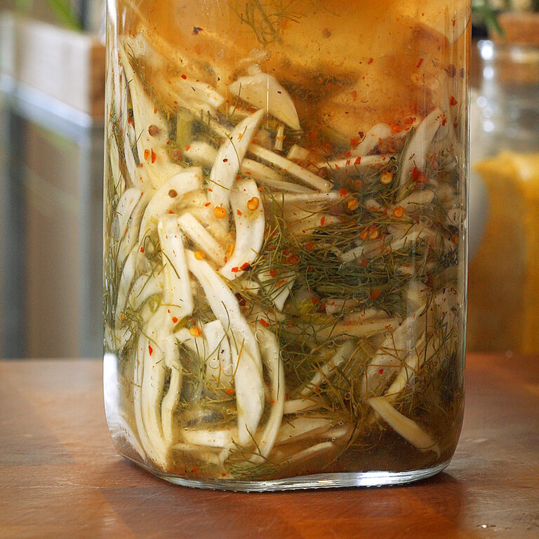 a bubbling jar full of fermented fennel and chili flakes