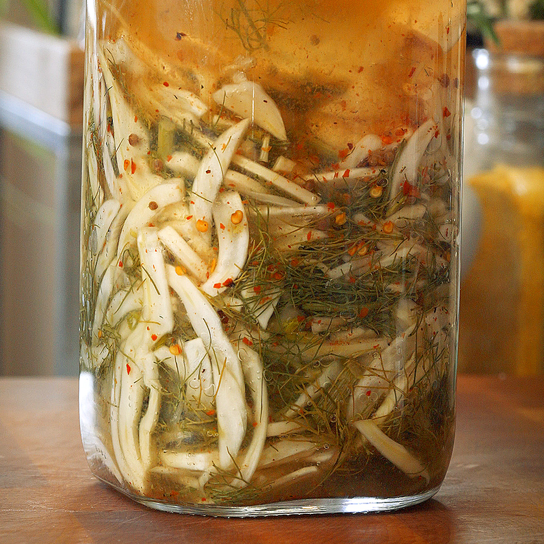 a bubbling jar full of fermented fennel and chili flakes