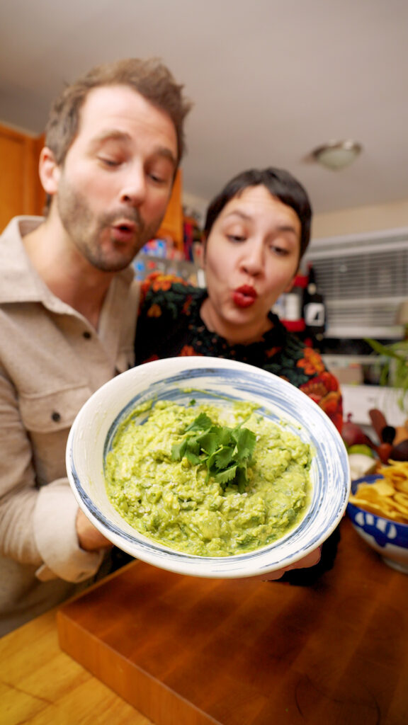 a big bowl of homemade guacamole with cilantro