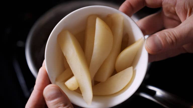 a small bowl full of cinnamon simmer pears