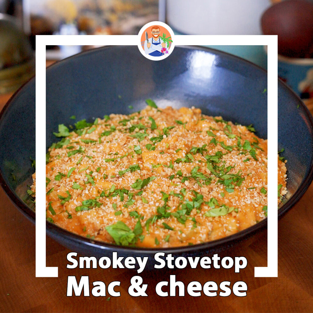 a big bowl of mac and cheese with herbs and toasted breadcrumbs