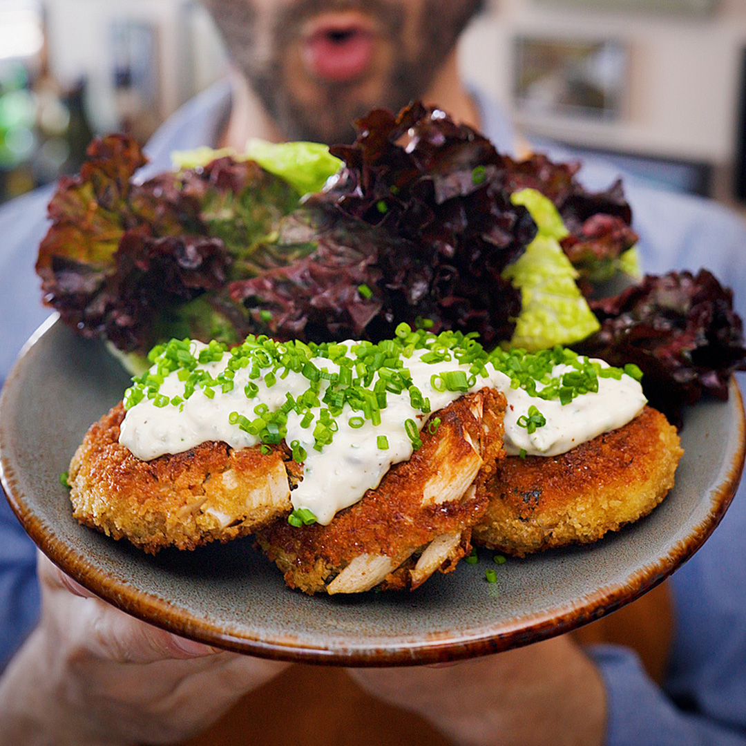 vegetarian crab cakes with homemade tartar sauce and mixed green salad on a plate