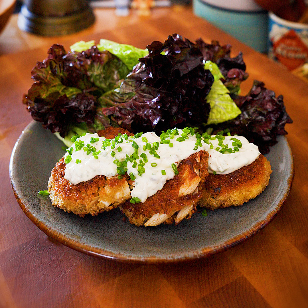 vegetarian crab cakes with homemade tartar sauce and mixed green salad on a plate